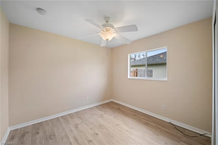 Unfurnished room featuring light hardwood / wood-style floors and ceiling fan