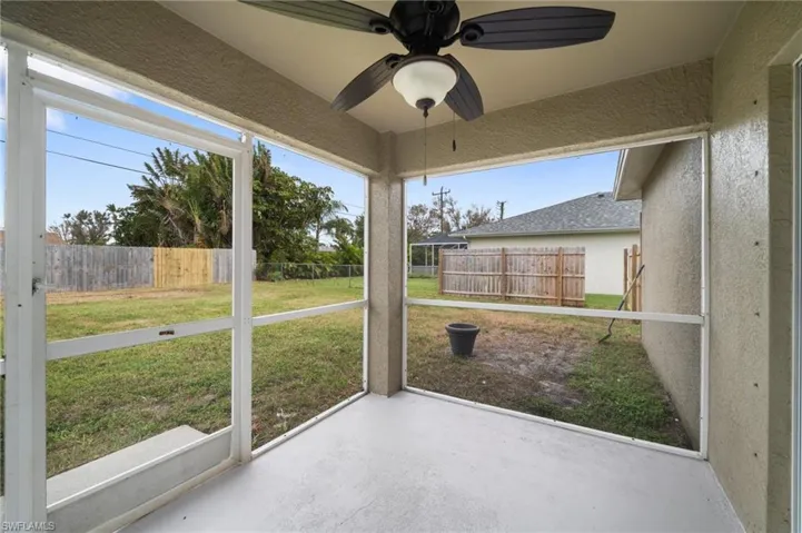 Unfurnished sunroom featuring ceiling fan