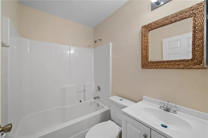 Full bathroom featuring vanity, bathing tub / shower combination, and toilet