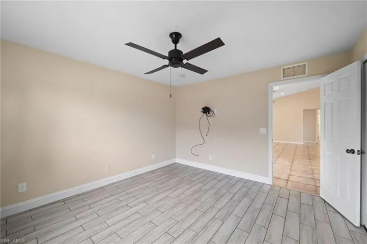 Unfurnished room featuring light hardwood / wood-style flooring and ceiling fan