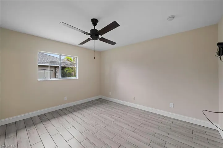 Empty room featuring light hardwood / wood-style flooring and ceiling fan