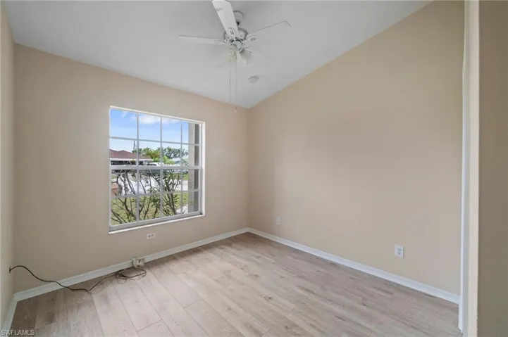 Unfurnished room featuring light wood-type flooring and ceiling fan