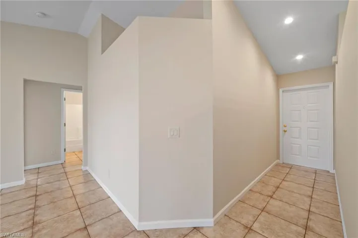 Hall with light tile patterned floors