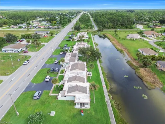 Aerial view of property's location with nearby suburban area and a large body of water