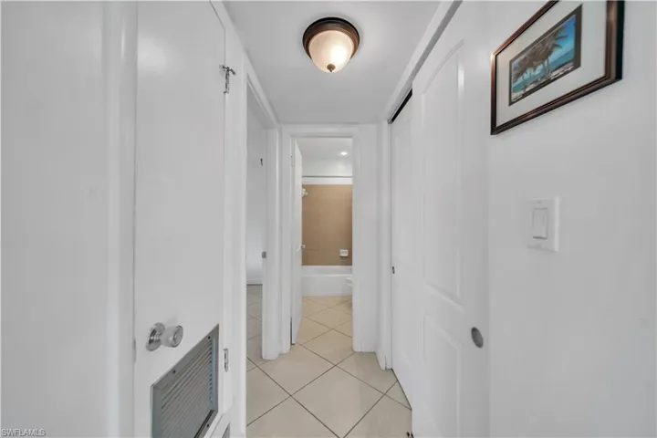 Hallway featuring light tile patterned floors and a barn door