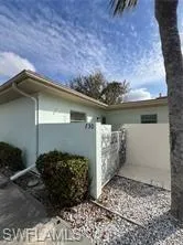 View of side of property featuring a gate