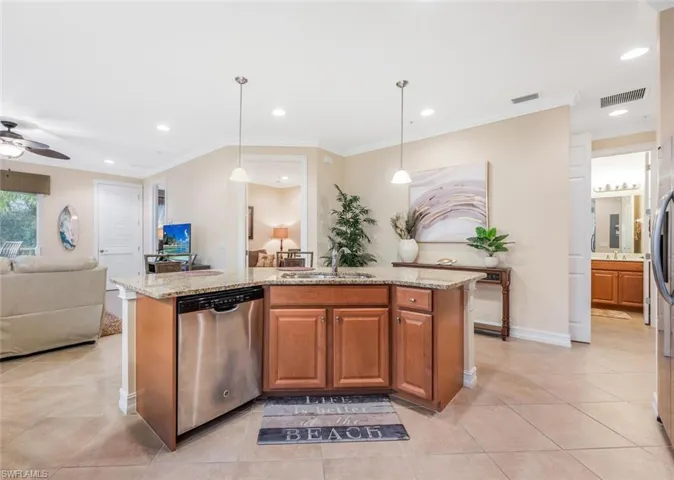 Kitchen with sink, an island with sink, ceiling fan, and stainless steel dishwasher