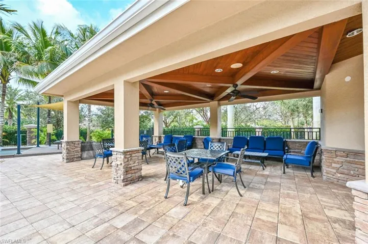View of patio with ceiling fan, an outdoor living space, and a gazebo