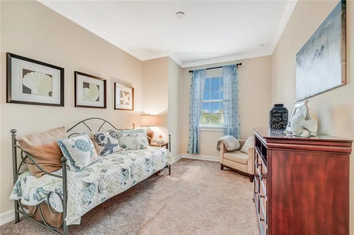 Bedroom featuring carpet floors and crown molding