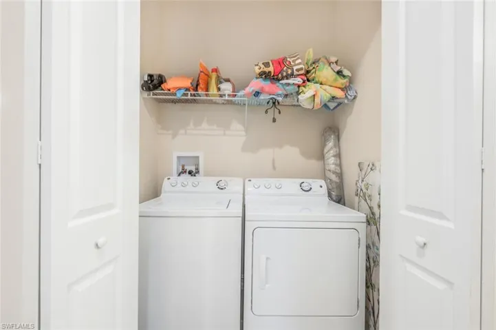 Laundry room with washing machine and clothes dryer