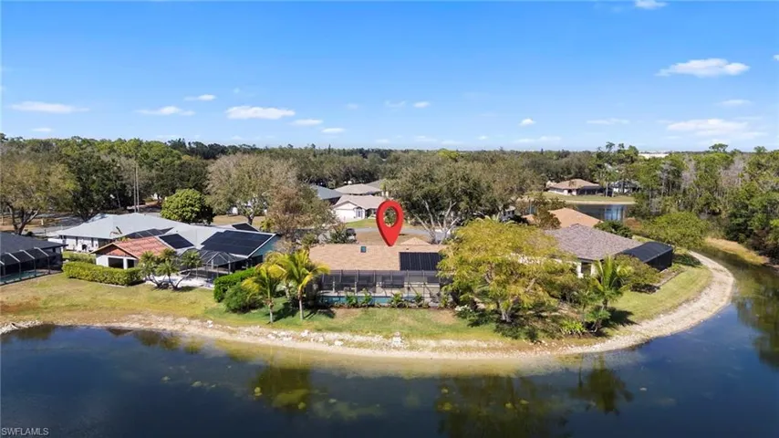 Drone / aerial view of a large body of water and a tree filled landscape