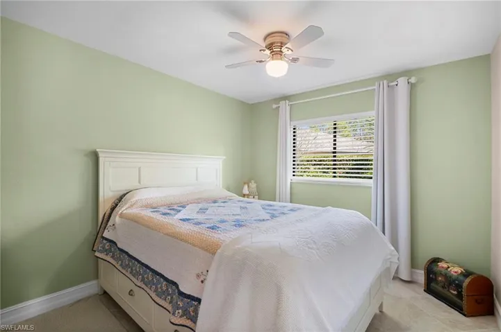 Bedroom with a ceiling fan and tile patterned flooring