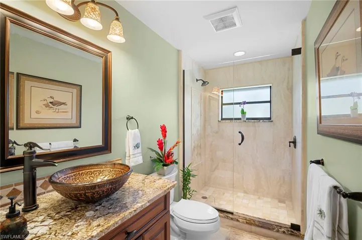 Bathroom featuring vanity and a stall shower