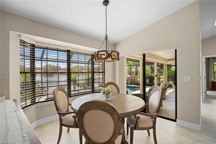 Dining space featuring hanging lights and vaulted ceiling