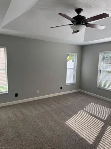 Unfurnished room with carpet floors and ceiling fan