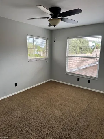 Unfurnished room with carpet floors and ceiling fan