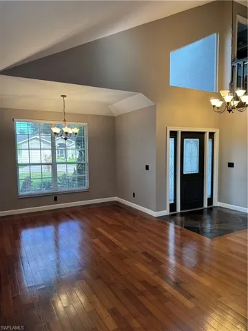 Foyer with a chandelier and wood-type flooring