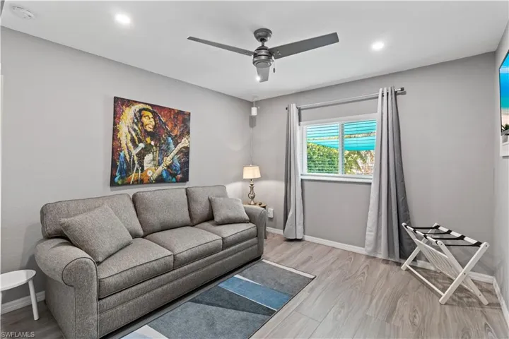Home office featuring ceiling fan, wood finished floors, a wall mounted air conditioner, and recessed lighting
