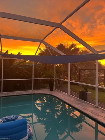 Outdoor pool with a lanai and a patio area