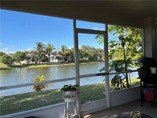 Sunroom / solarium featuring a water view