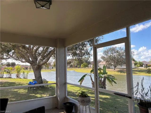 Sunroom / solarium featuring a water view, a residential view, and healthy amount of natural light