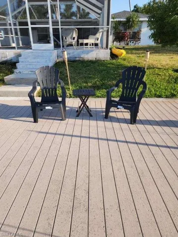 Wooden deck with a lawn and glass enclosure