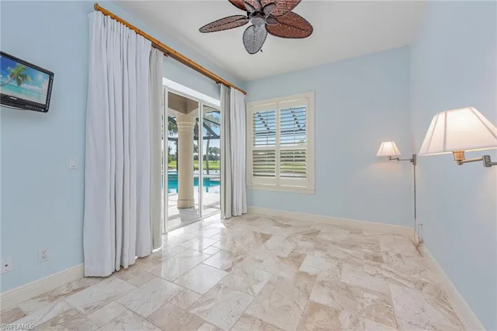 Empty room with baseboards and a ceiling fan