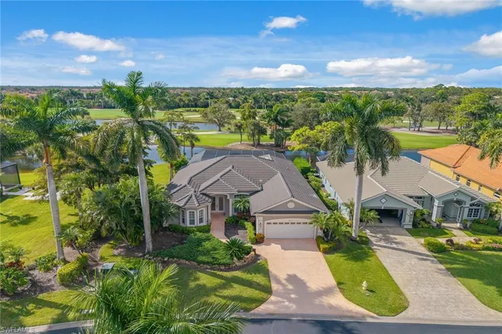 View from above of property with a local golf course and a nearby body of water