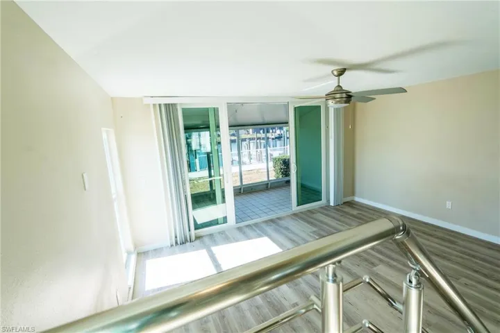 Waterfront sunroom living area from stairway
