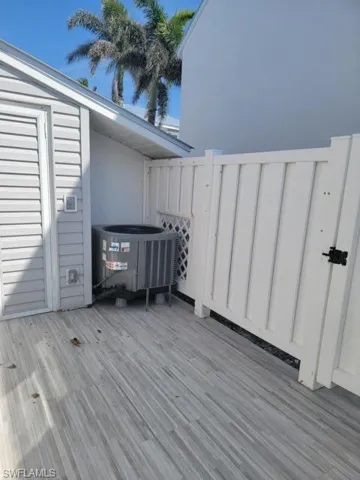 Front terrace featuring central AC unit and storage shed