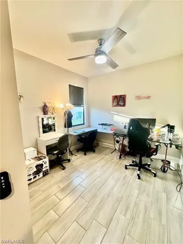 Home office featuring wood tiled floors and a ceiling fan