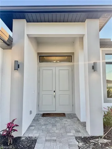 Entrance to property with stucco siding