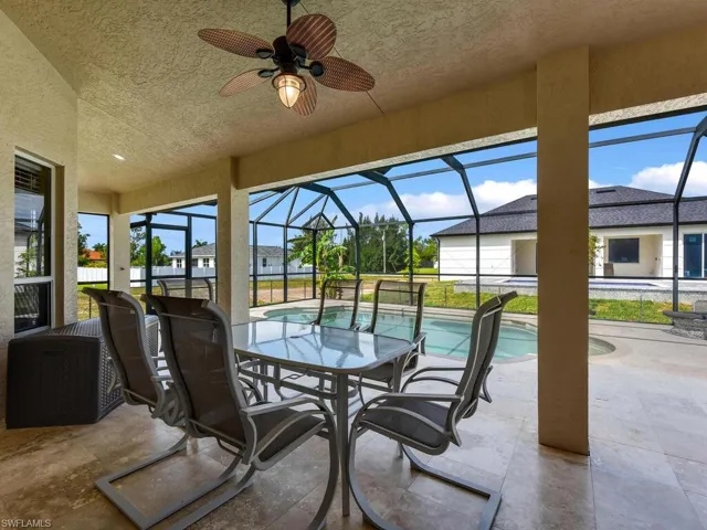 View of patio featuring an outdoor pool, a ceiling fan, and a lanai