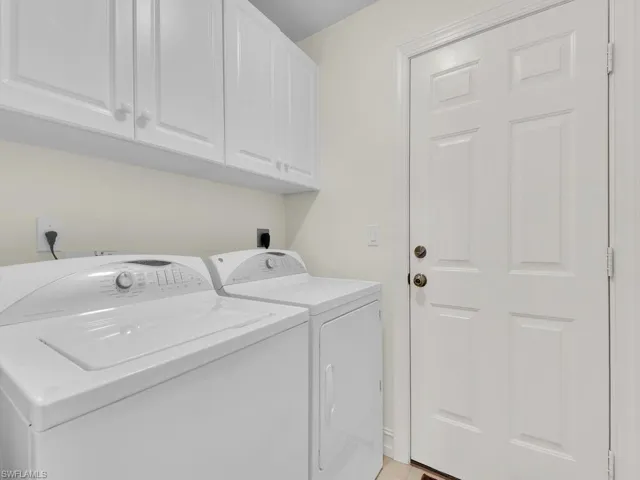 Laundry area featuring cabinet space and separate washer and dryer