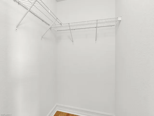 Walk in closet with wood finished floors