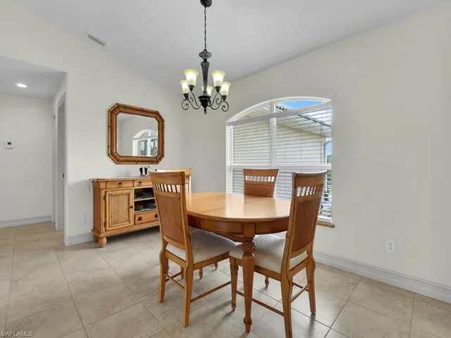 Dining space featuring a chandelier, baseboards, and light tile patterned floors