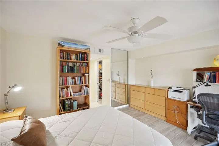 Bedroom with ceiling fan, a closet, and light wood-type flooring
