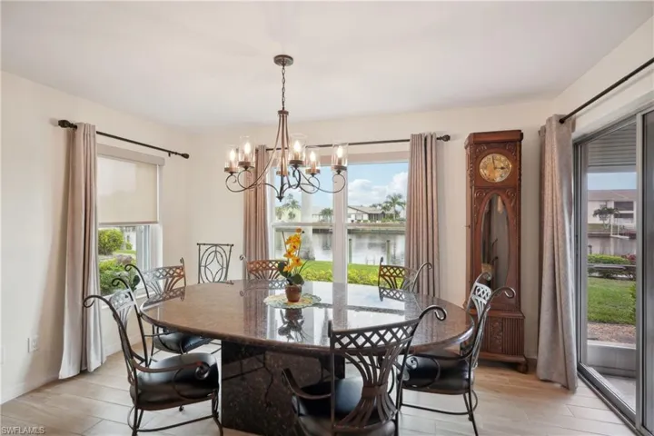 Dining area with a water view and an inviting chandelier