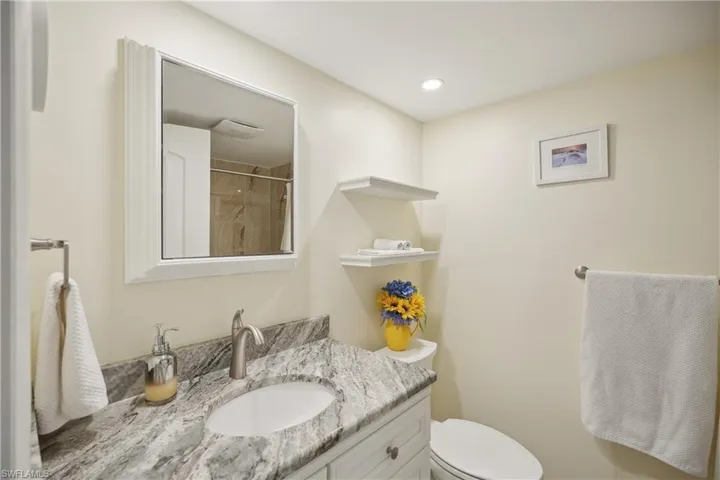 Bathroom with vanity, toilet, and a shower