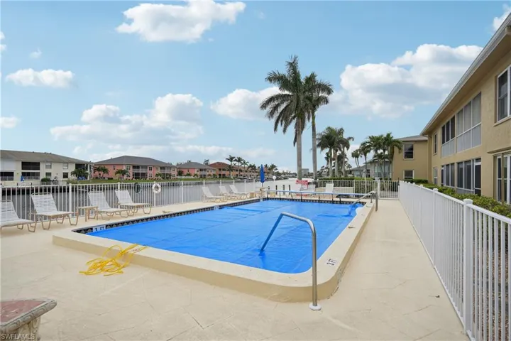 View of pool featuring a water view and a patio