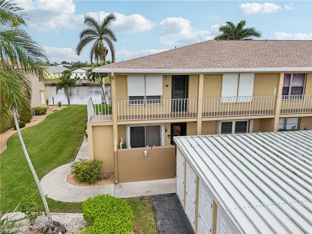 View of property featuring a garage and a water view