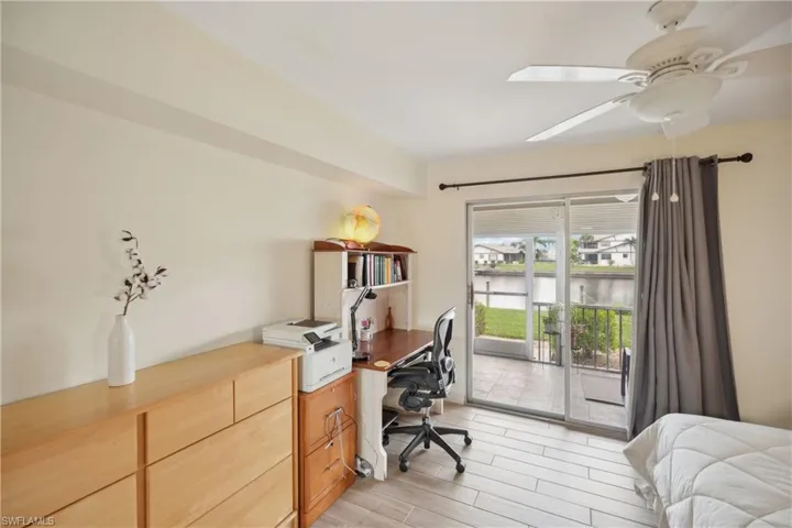 Home office featuring ceiling fan and a water view