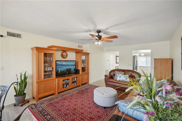Living room with ceiling fan and wood-type flooring