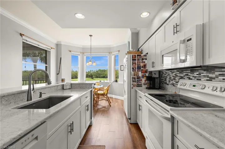 Modern kitchen with white cabinetry and light-toned countertops