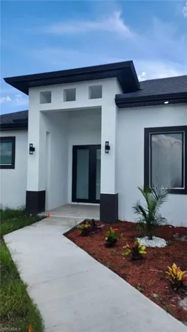 Doorway to property featuring stucco siding
