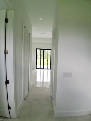 Hallway with baseboards and recessed lighting