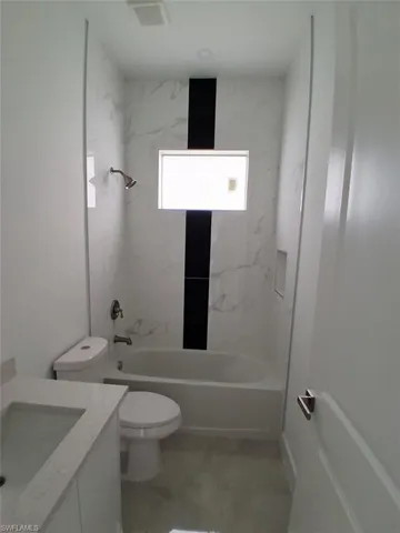 Full bathroom 2 with vanity and shower / tub combination
