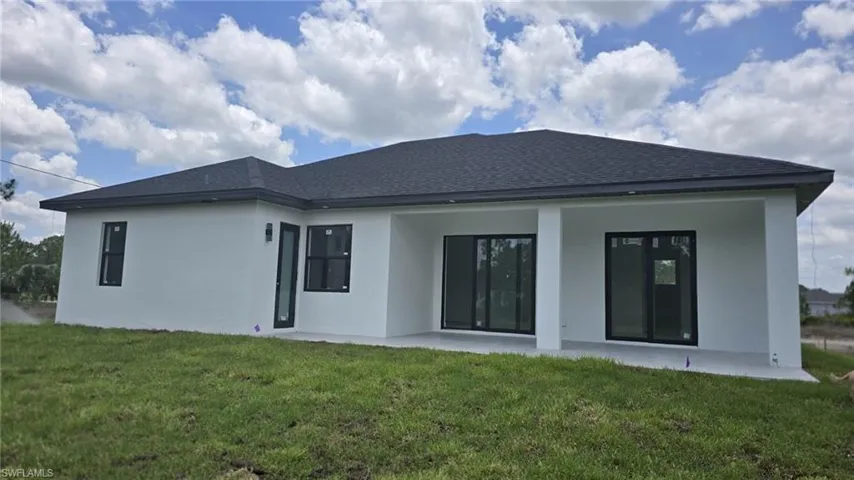 Back of house with a extended patio area.