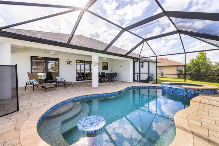 Spacious pool deck and under truss lanai with screened enclosure