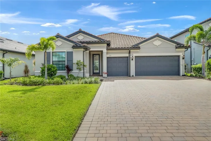 View of front of home with a garage and a front yard